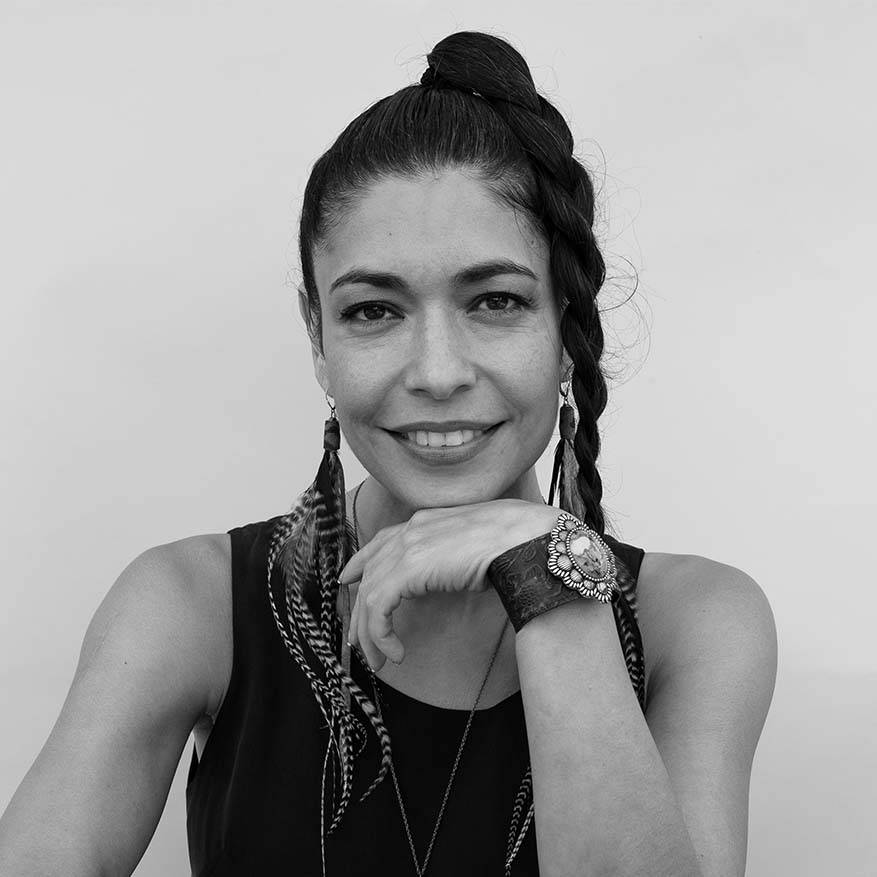 Black and white photograph of Caridad de la Luz, also known as La Bruja, founder of a community art space in Soundview, Bronx called El Garaje