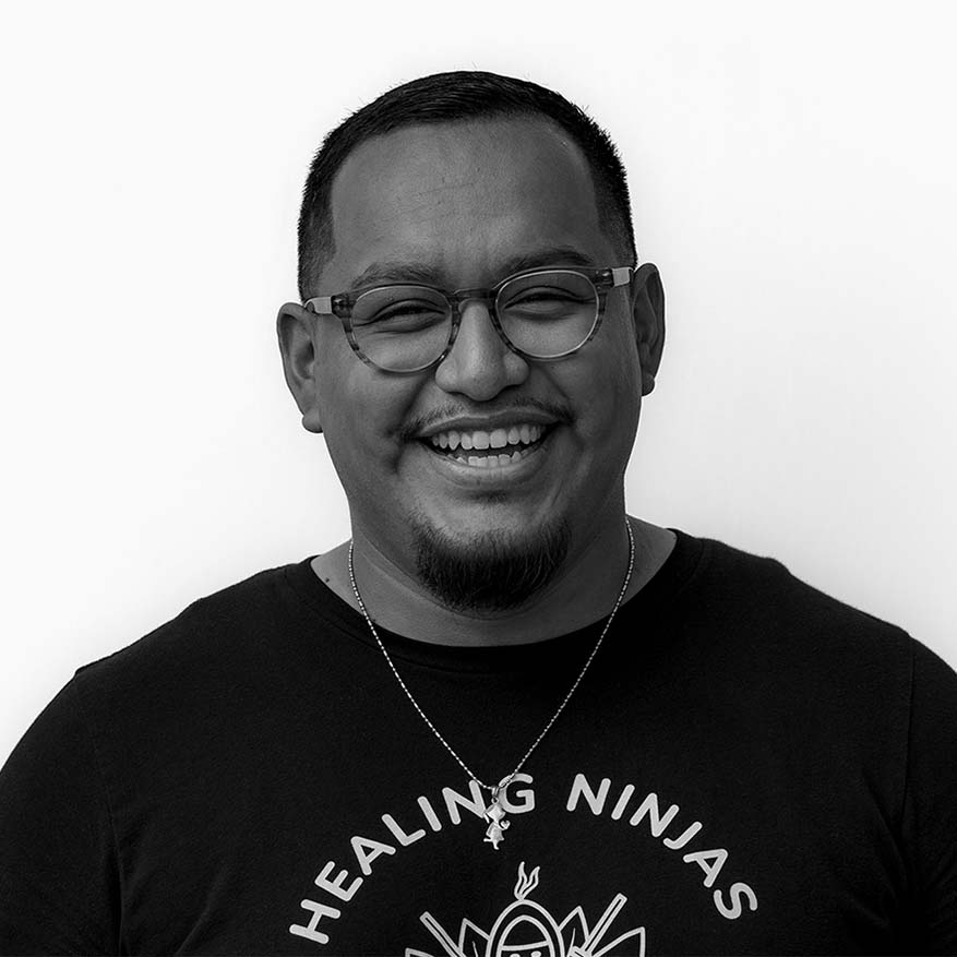 Black and white image of Hernan Carvente-Martinez who is increasing access to healing and wellness resources for communities of color in NYC.